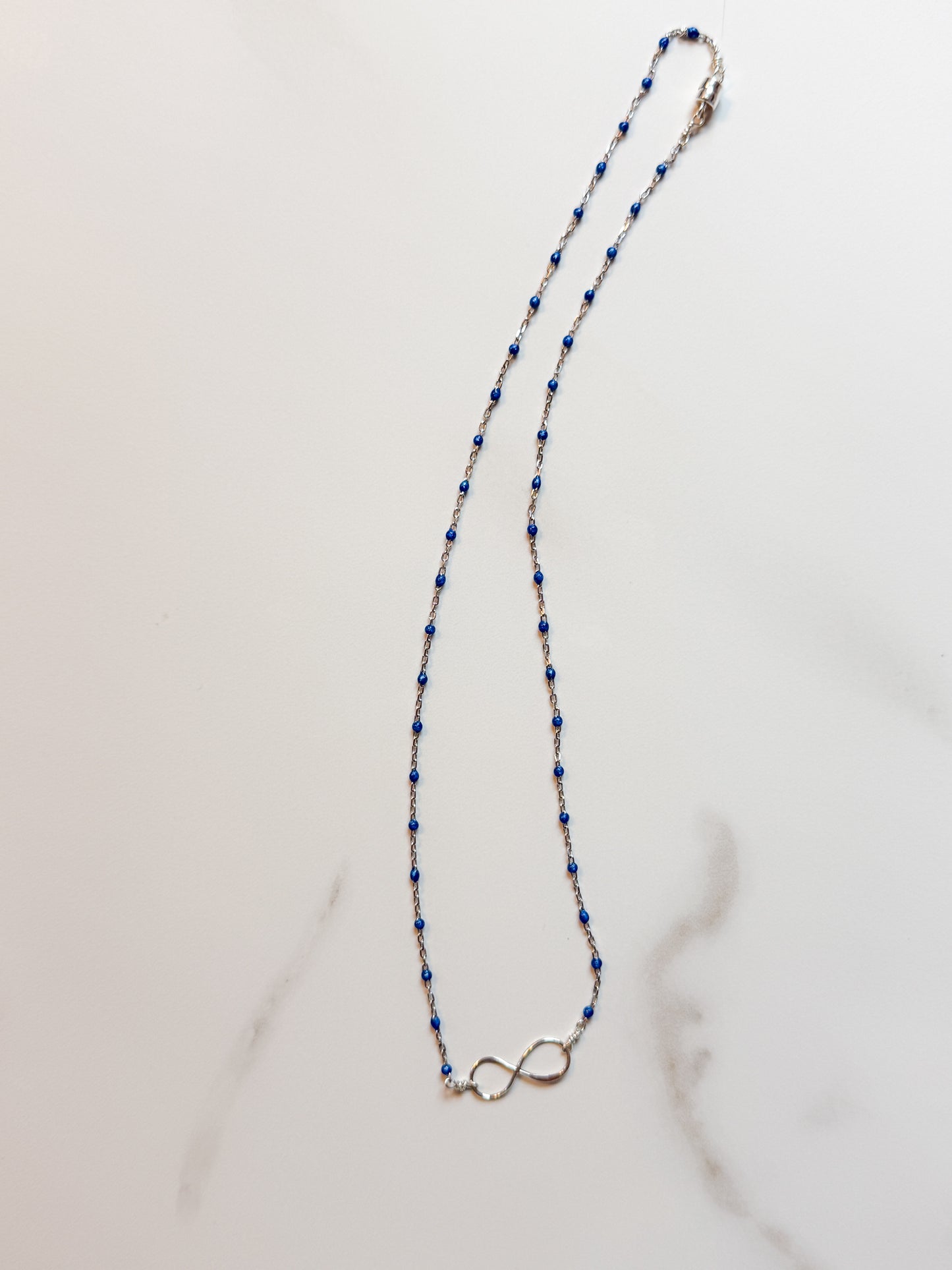 Delicate sterling infinity and blue enamel necklace