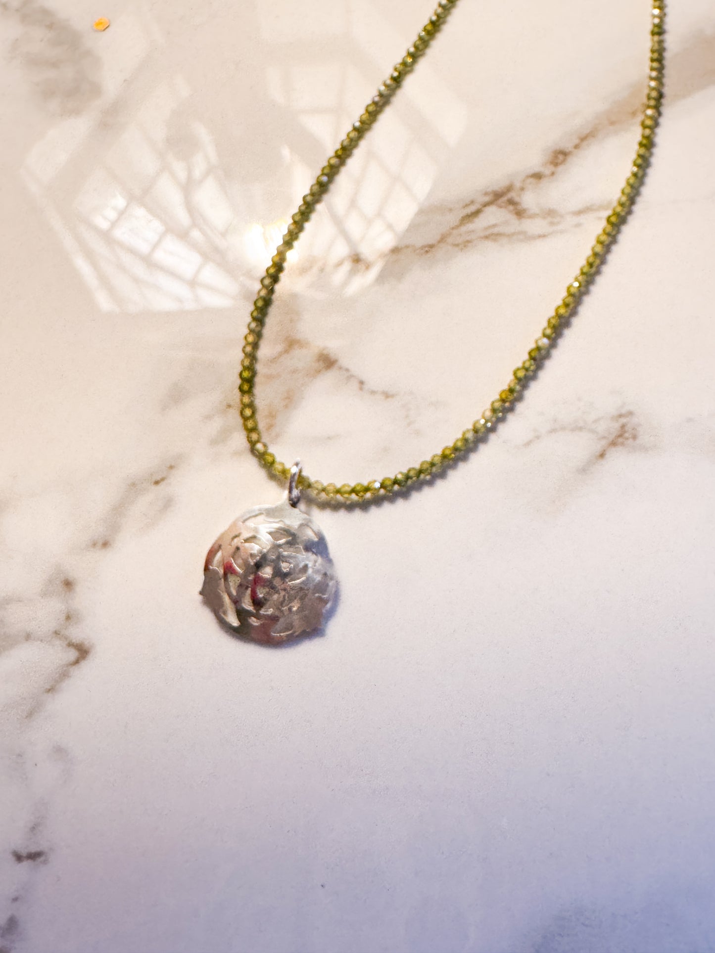 Celtic design with green zircon