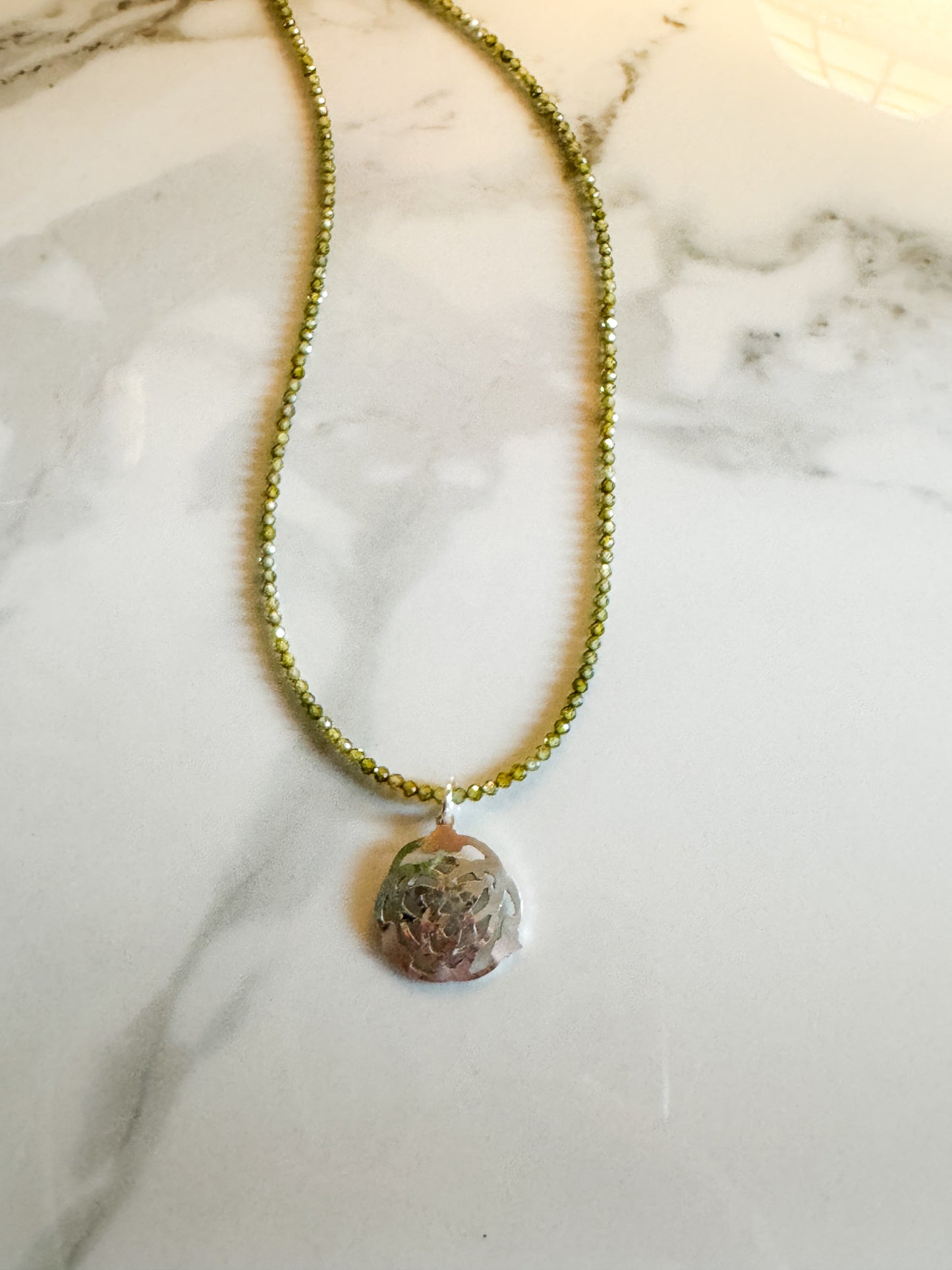 Celtic design with green zircon