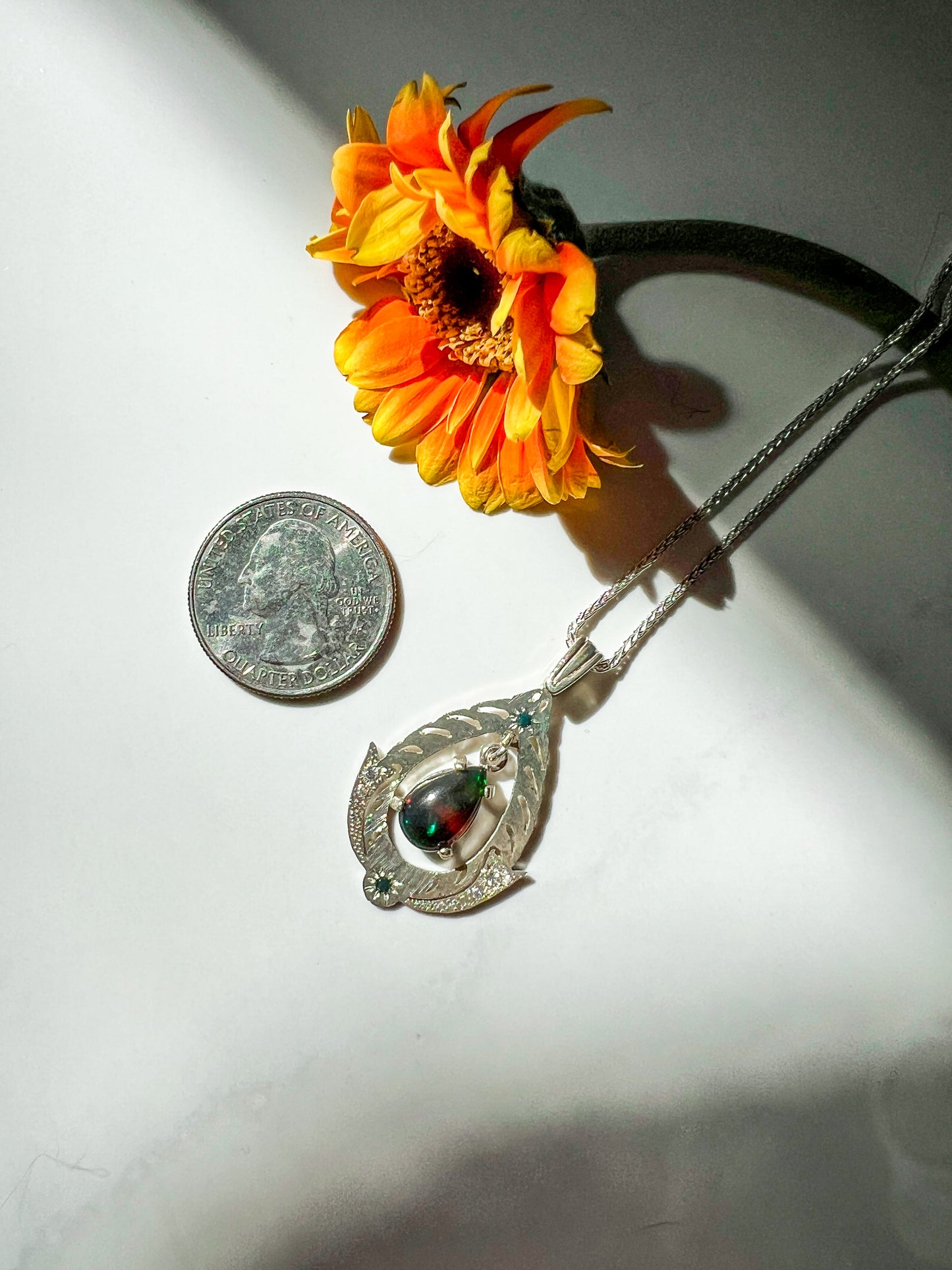 Black Opal drop pendant with blue diamond, white zircon & Moissanite