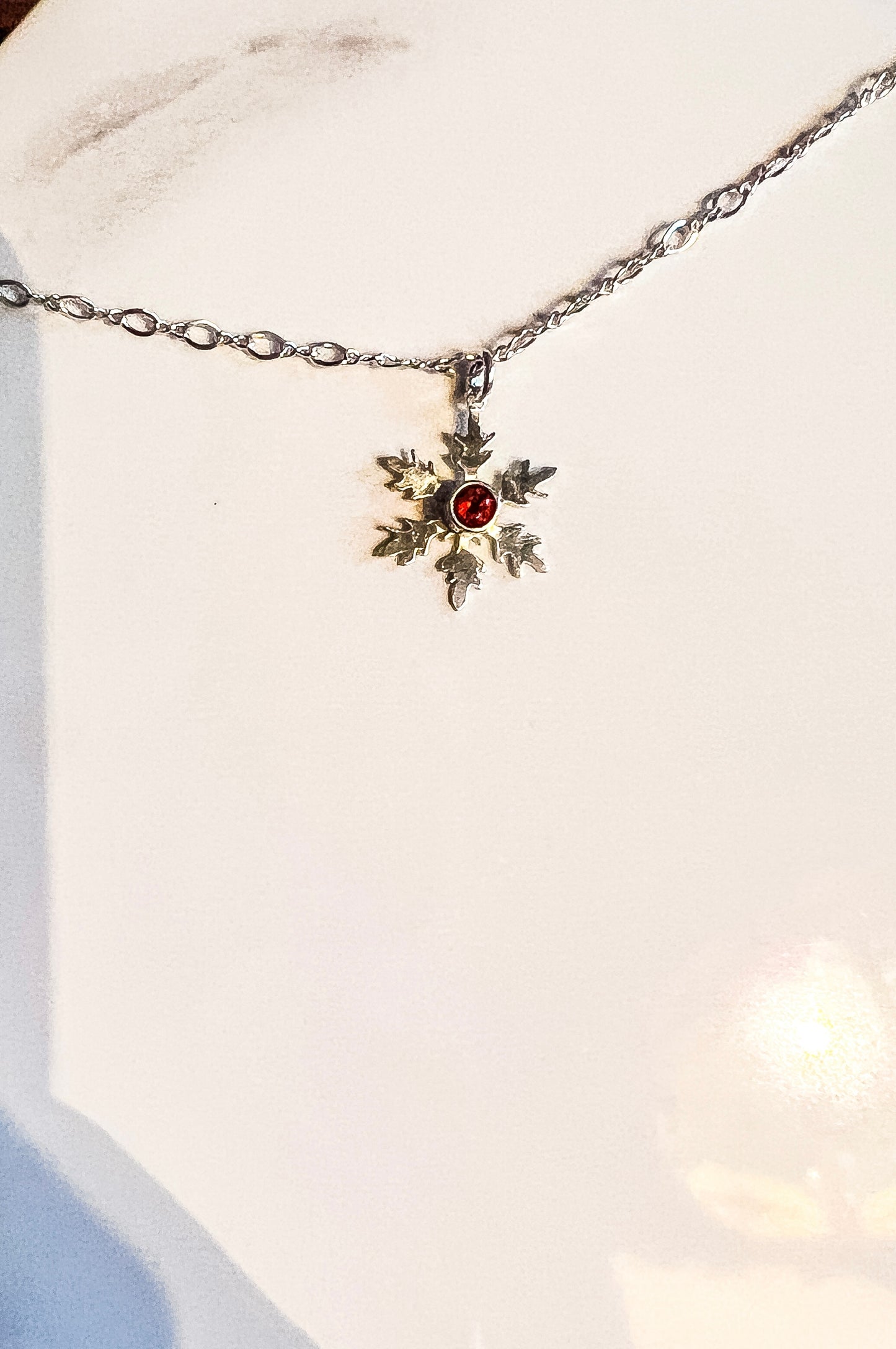 Hand cut snowflake and garnet necklace