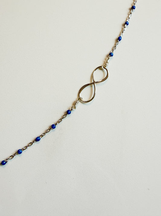 Delicate sterling infinity and blue enamel necklace