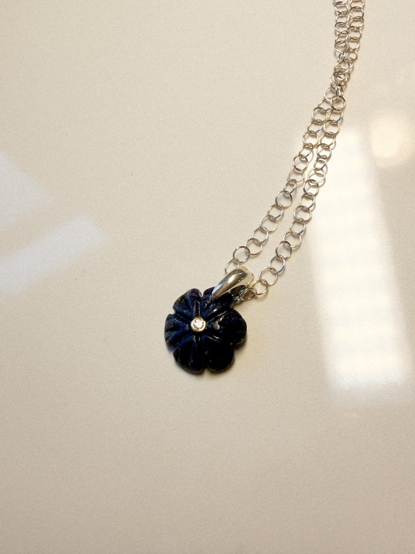 Deep blue Lapis carved flower with Zircon