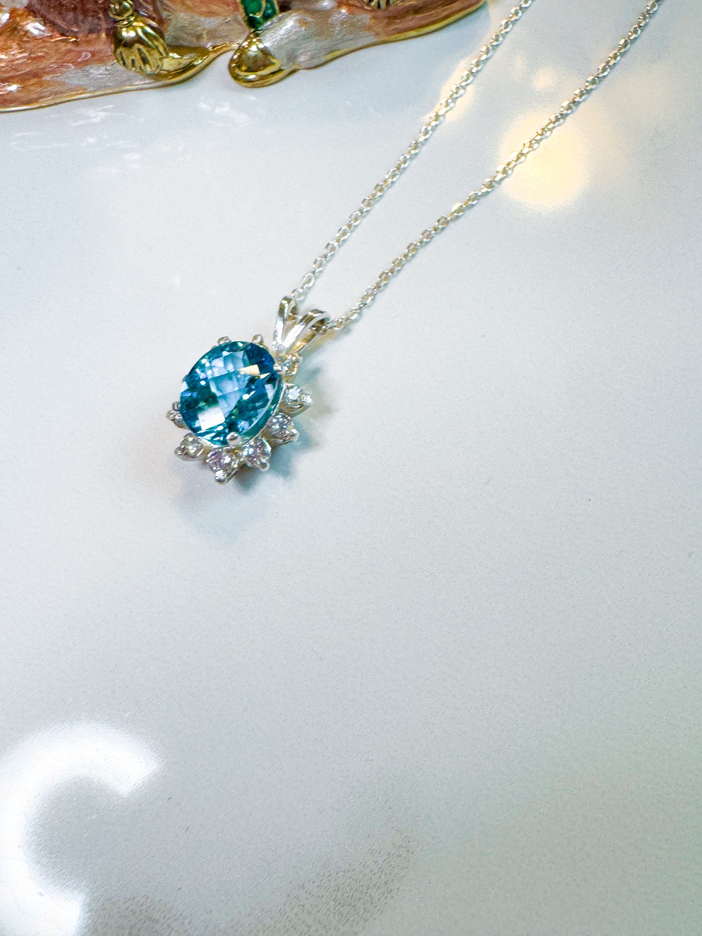 Fancy cut Swiss blue topaz and CZ pendant