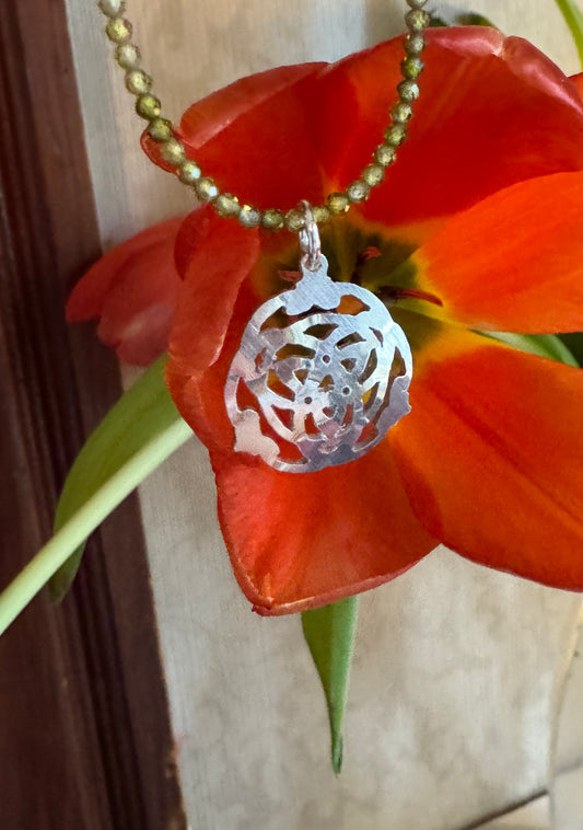 Celtic design with green zircon