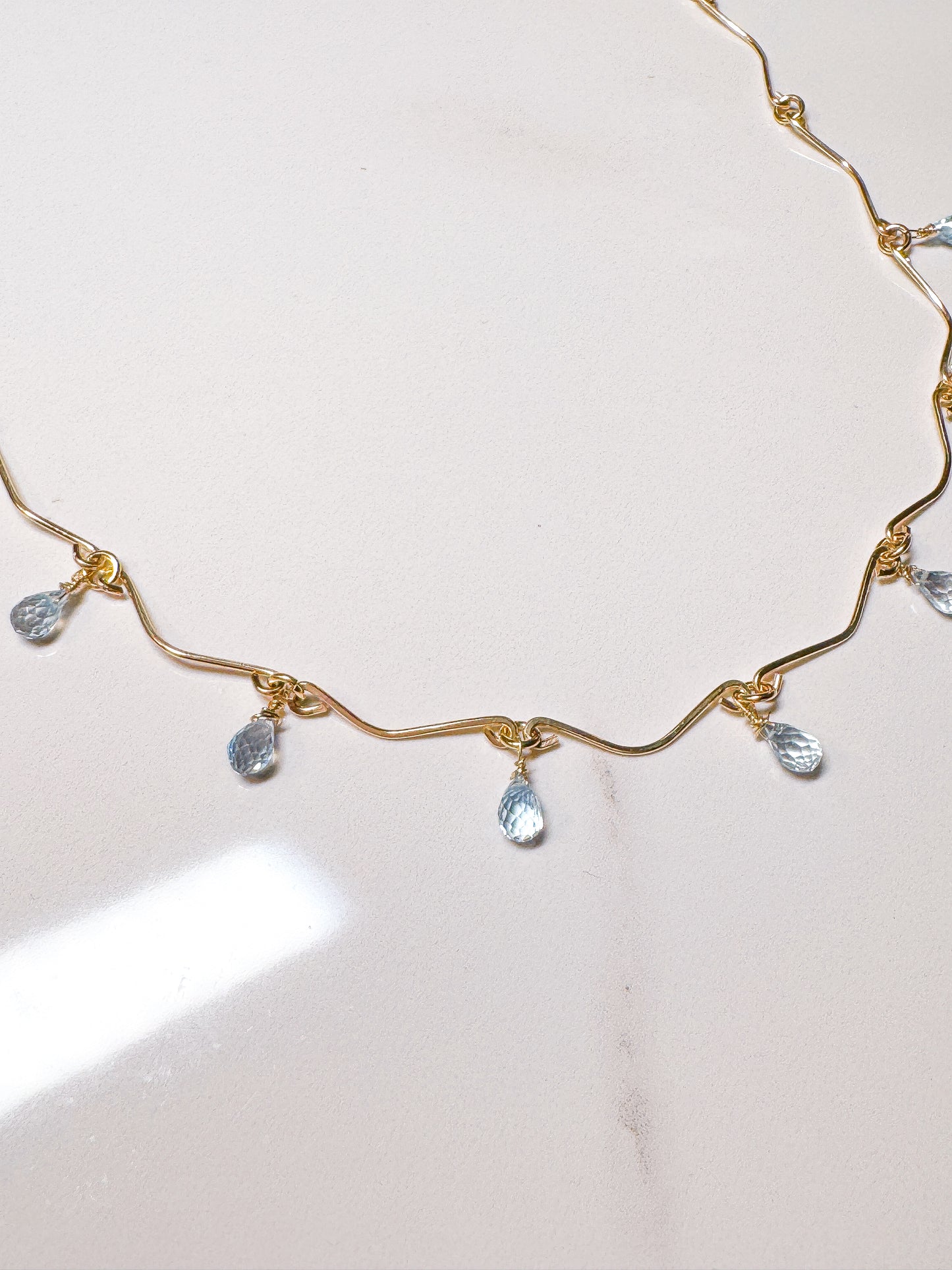 Gold filled hammered necklace with blue Topaz