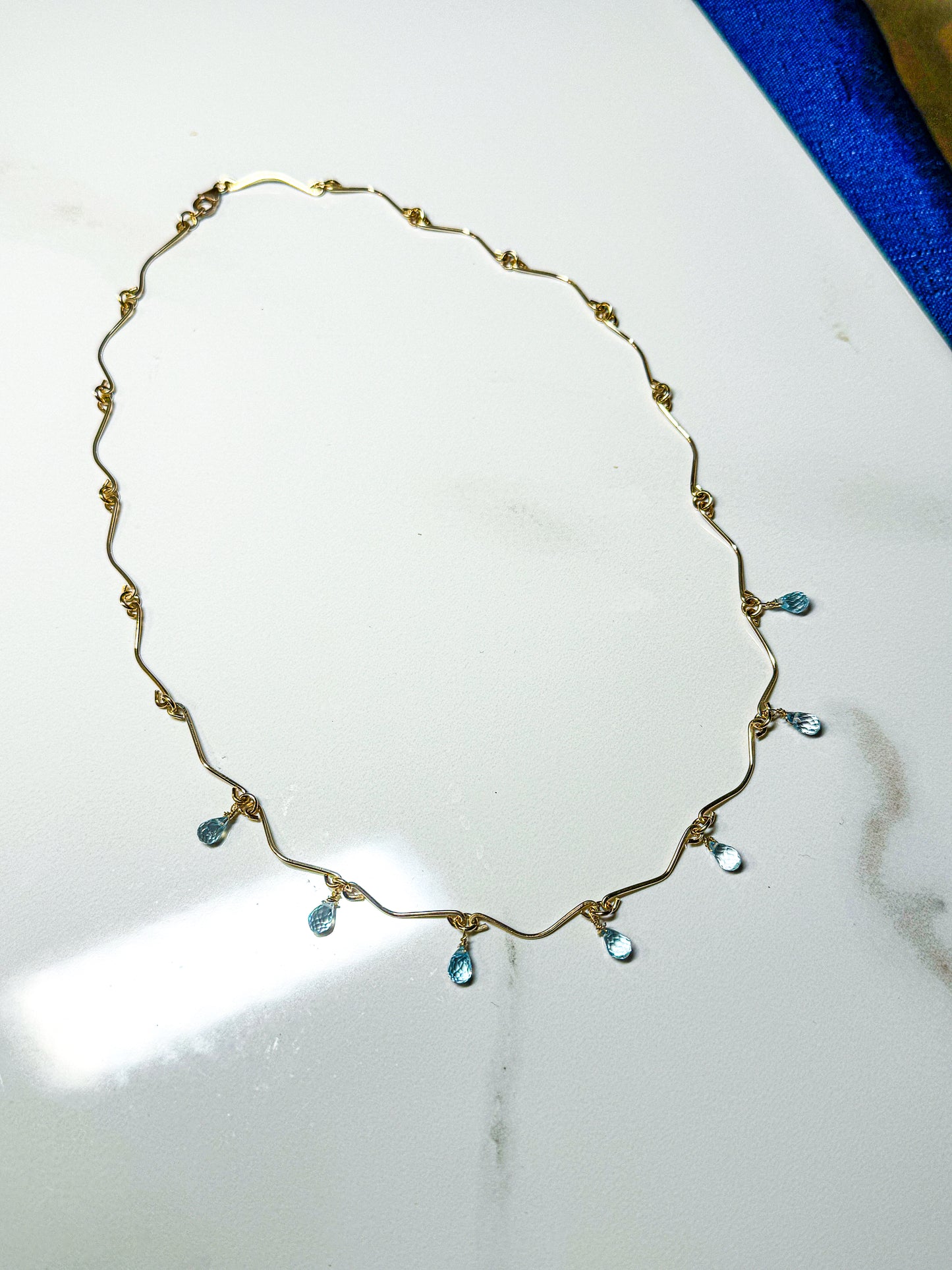 Gold filled hammered necklace with blue Topaz