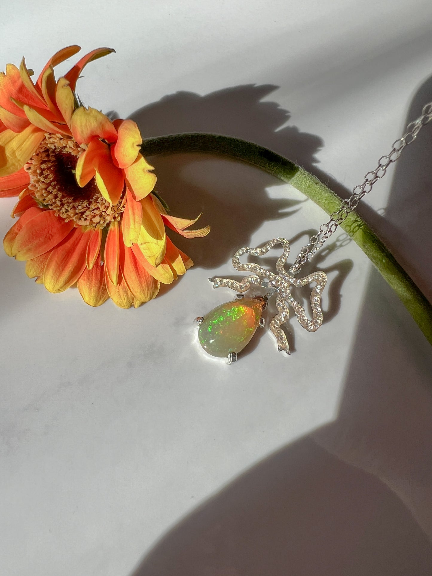Ethiopian Opal hand cut crystal bow pendant