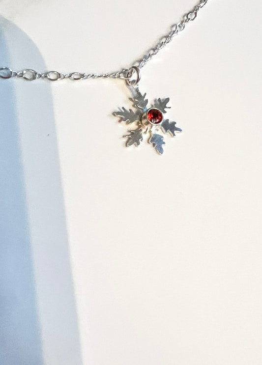 Hand cut snowflake and garnet necklace